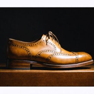 Handcrafted from a single piece of full-grain Italian calf leather, this Goodyear welted Oxford features hand-punched broguing, a testament to generations of skilled artisans.